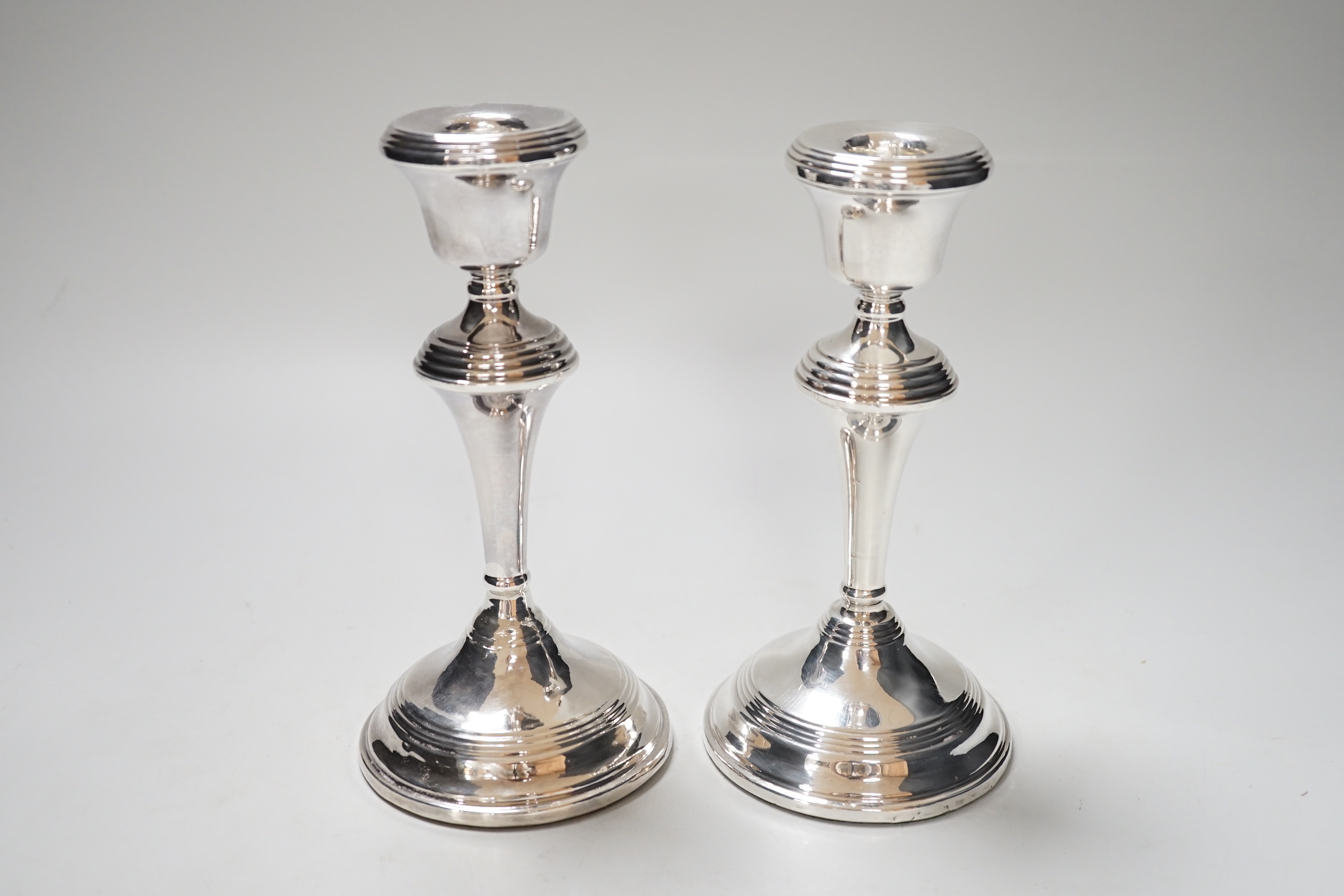 A pair of Elizabeth II silver candlesticks, loaded, Birmingham 1959, 17.5cm